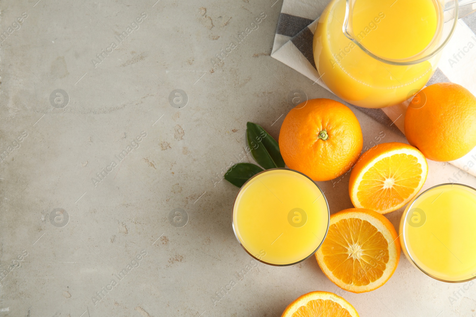 Photo of Flat lay composition with orange juice, fresh fruit and space for text on light background