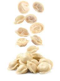 Image of Many tasty dumplings falling on white background