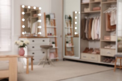 Blurred view of elegant room with dressing table and wardrobe. Interior design