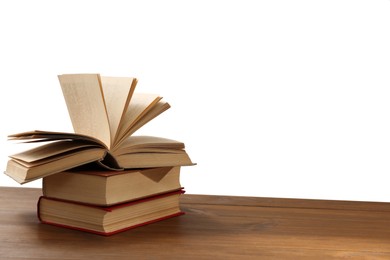 Stack of books on wooden table against white background. Library material