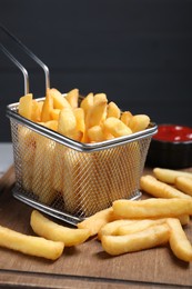 Photo of American cuisine. Tasty French fries on wooden table