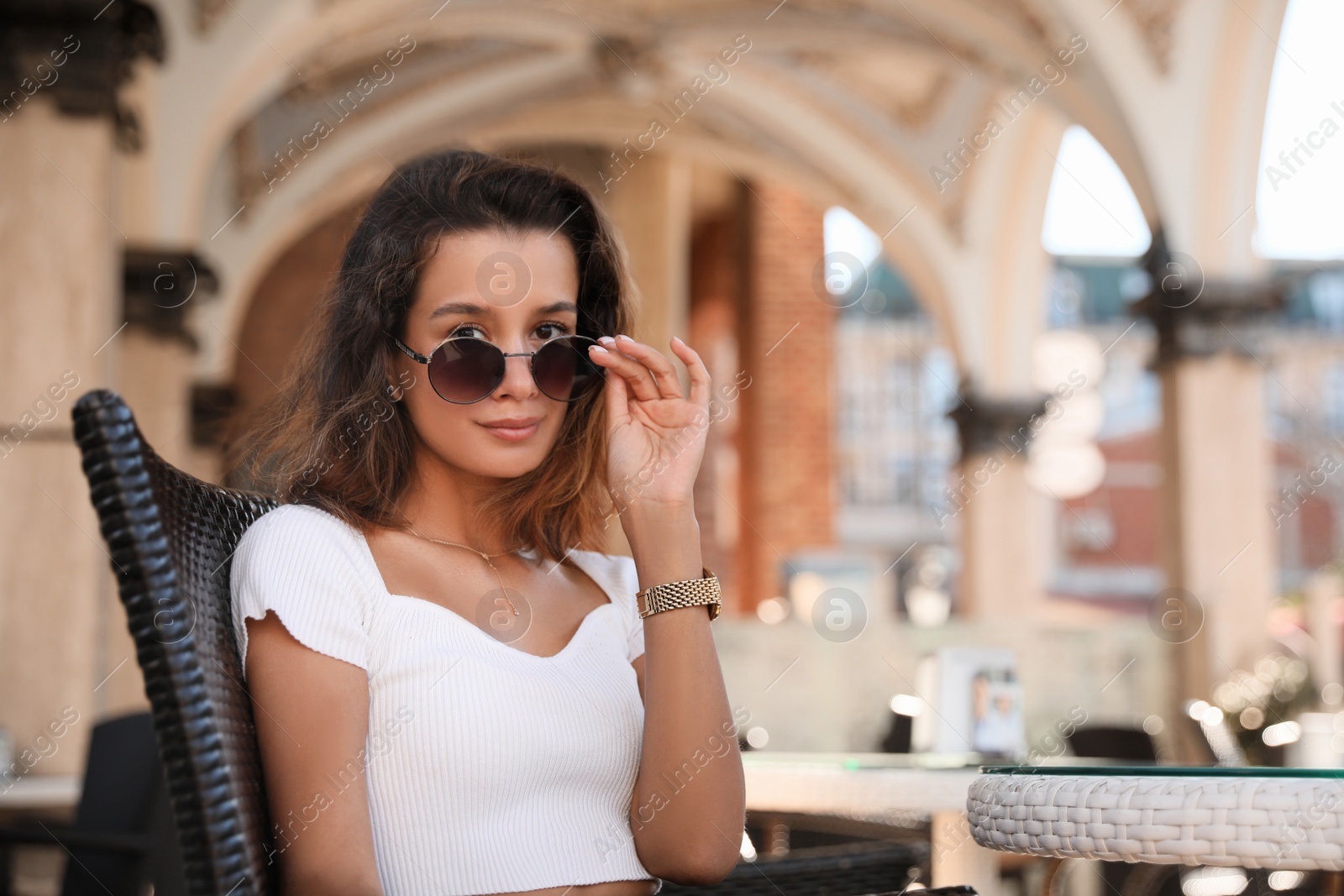 Photo of Portrait of beautiful young woman in outdoor cafe