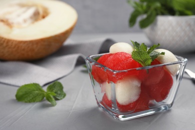 Bowl with melon and watermelon balls on table