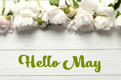 Image of Hello May. Beautiful blooming peony flowers on wooden background, top view