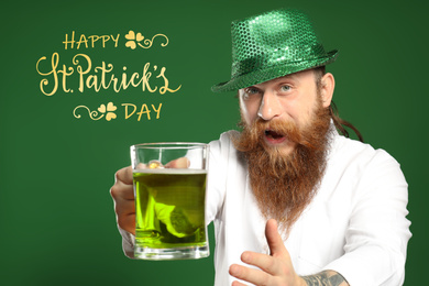 Image of Man with green beer on color background. St. Patrick's Day celebration