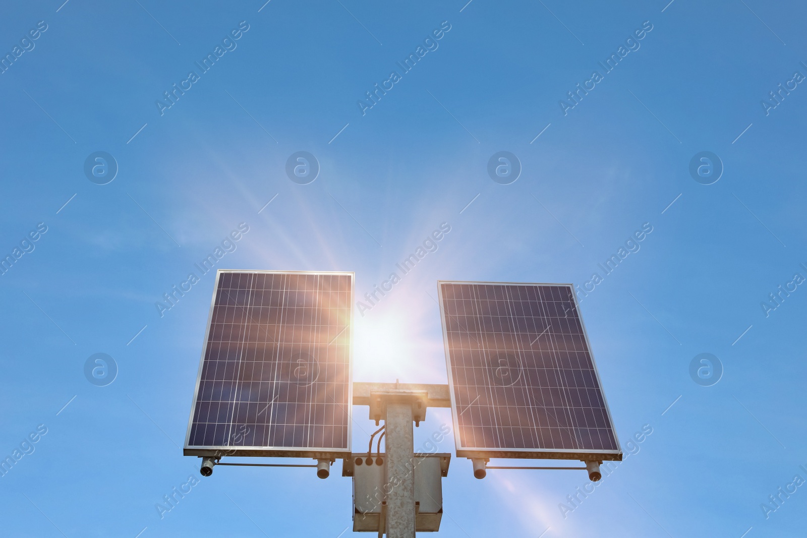 Photo of Modern solar panels against blue sky, low angle view. Alternative energy