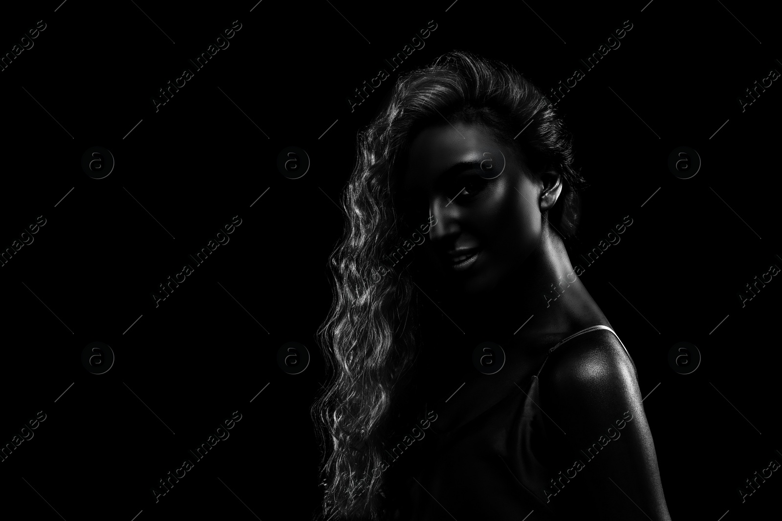 Image of Silhouette of woman in darkness. Portrait on black background