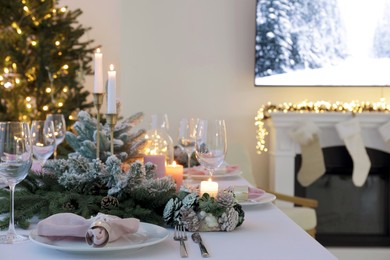 Beautiful festive table setting with Christmas decor in room