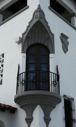 Photo of Exterior of building with beautiful window and balcony, low angle view