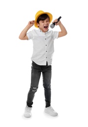 Photo of Cute little boy singing into microphone on white background