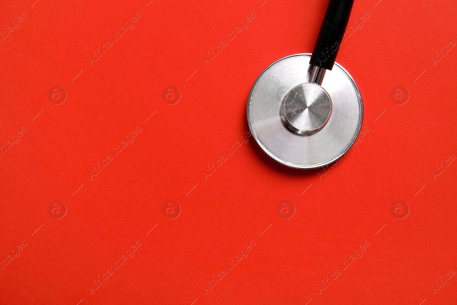 Photo of Stethoscope with space for text on color background, top view. Medical tool