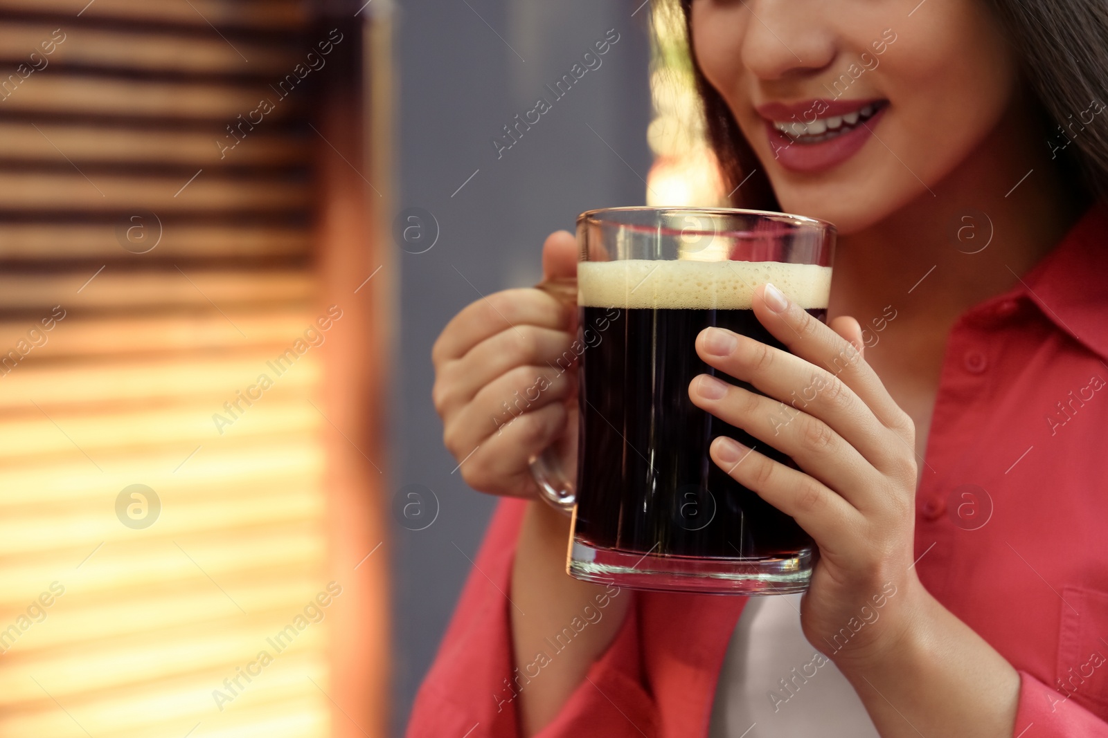 Photo of Young woman with cold kvass outdoors, closeup. Traditional Russian summer drink