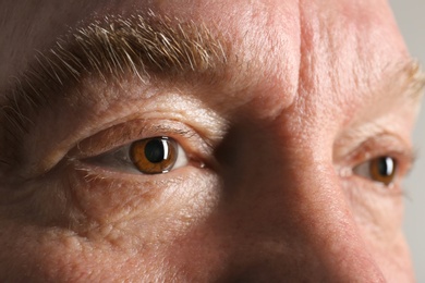 Wrinkled face of elderly man, closeup of eyes