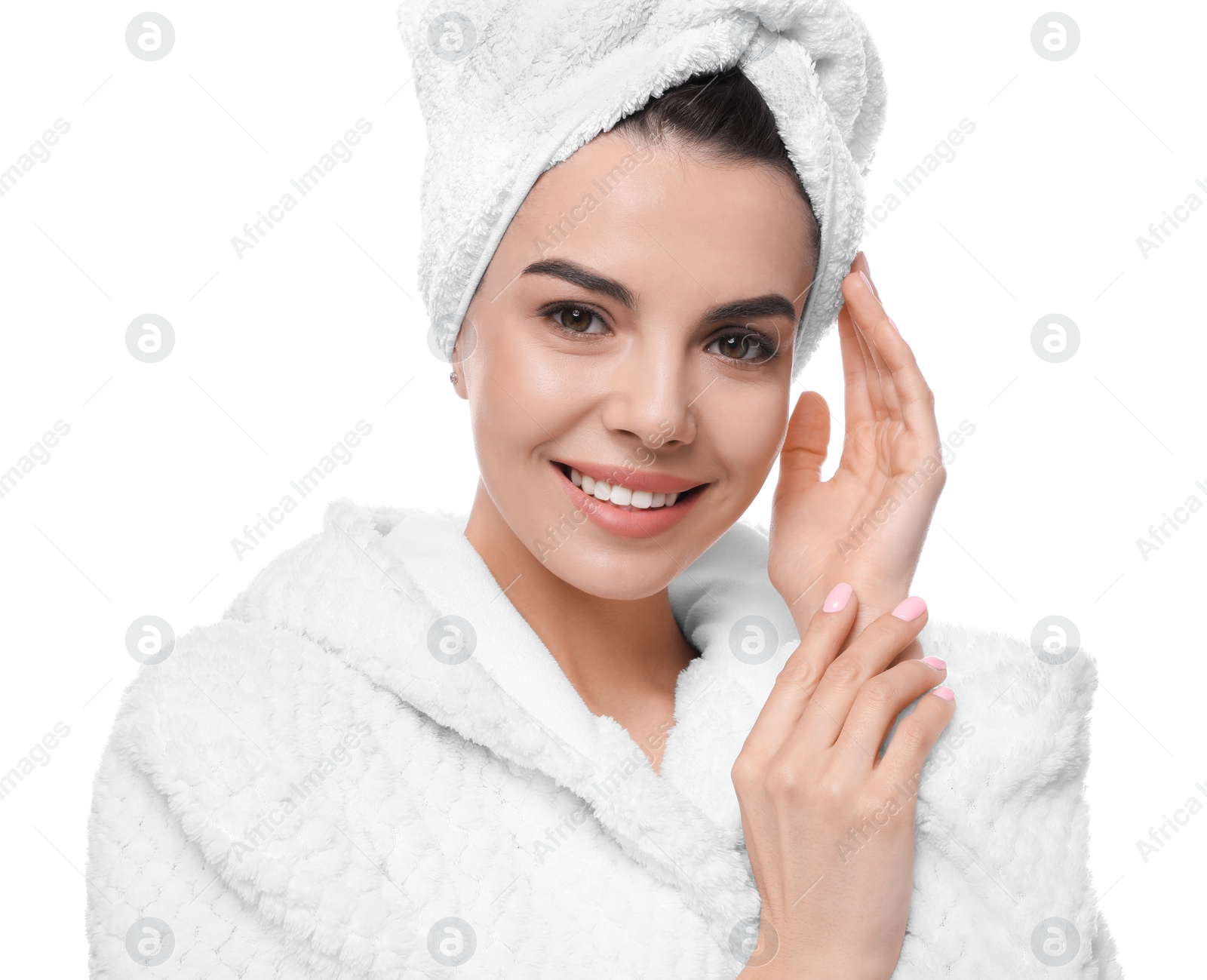 Photo of Happy young woman in bathrobe with towel on head against white background. Washing hair