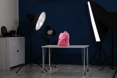 Photo of Shooting of bright backpack for product promotion in photo studio