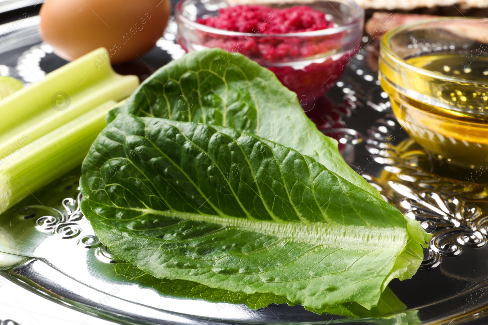 Photo of Closeup view of Passover Seder plate (keara) with traditional meal. Pesah celebration