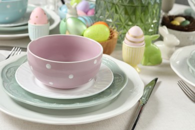 Easter celebration. Festive table setting with painted eggs.