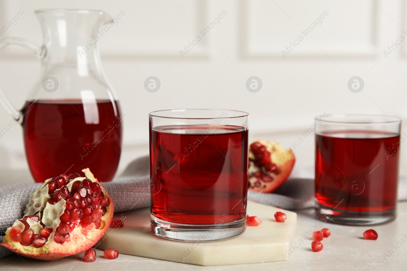 Photo of Freshly made pomegranate juice on light table