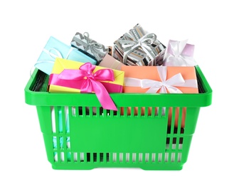 Green shopping basket with different gifts on white background