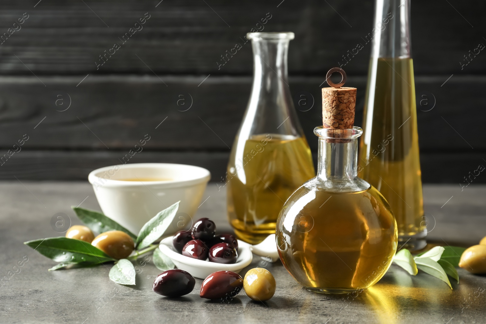 Photo of Composition with fresh olive oil on table