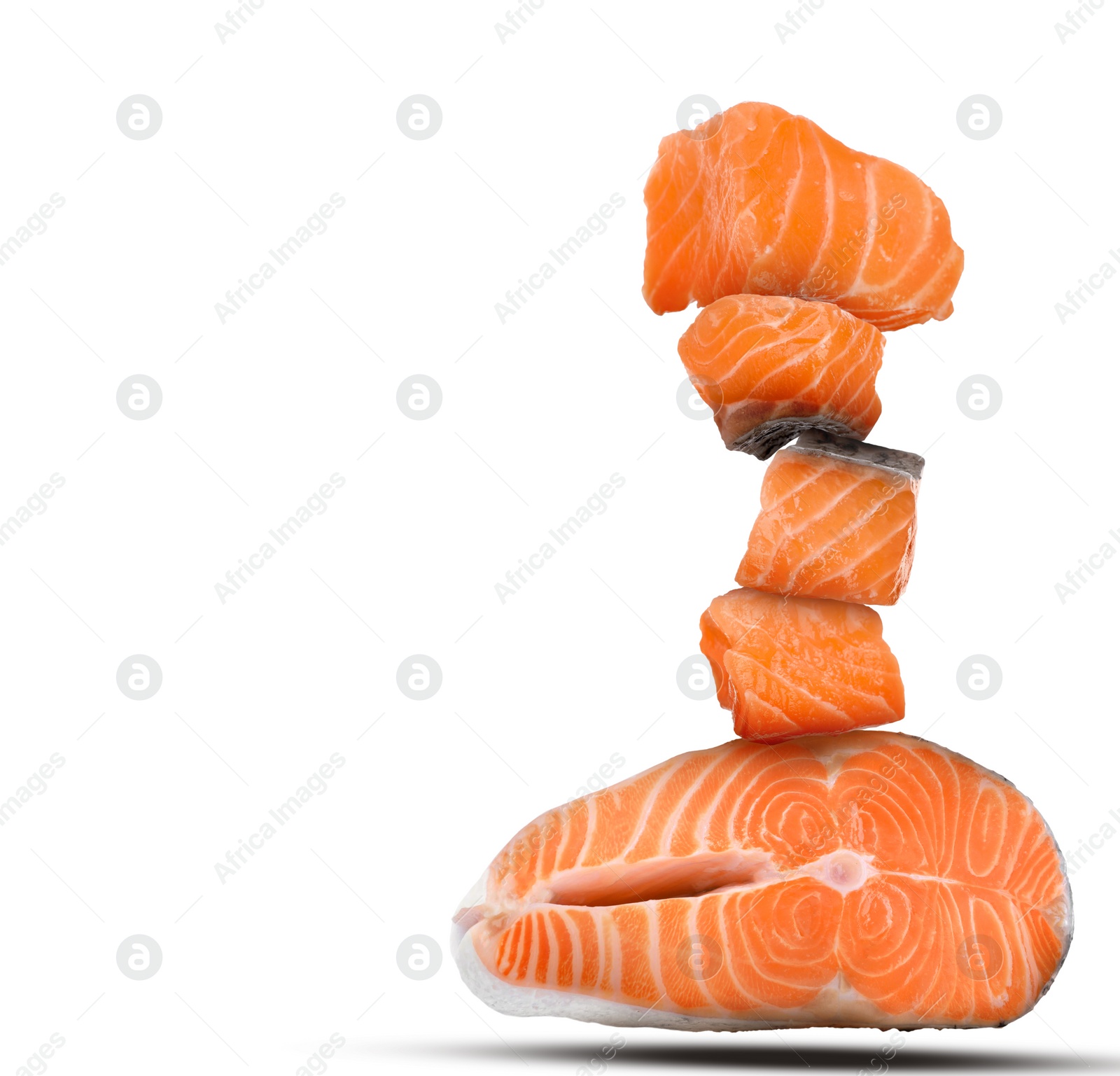 Image of Cut fresh salmon falling on white background