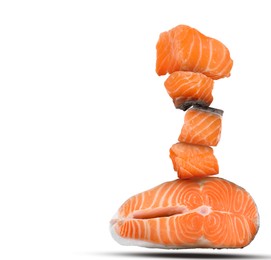 Image of Cut fresh salmon falling on white background