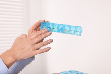 Photo of Doctor holding box of pills in clinic, closeup. Patient consultation