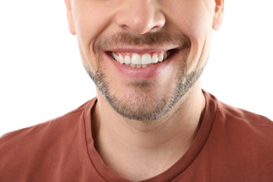 Photo of Smiling man with perfect teeth on white background, closeup