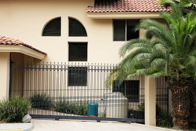 Grey metal gates near private estate on street