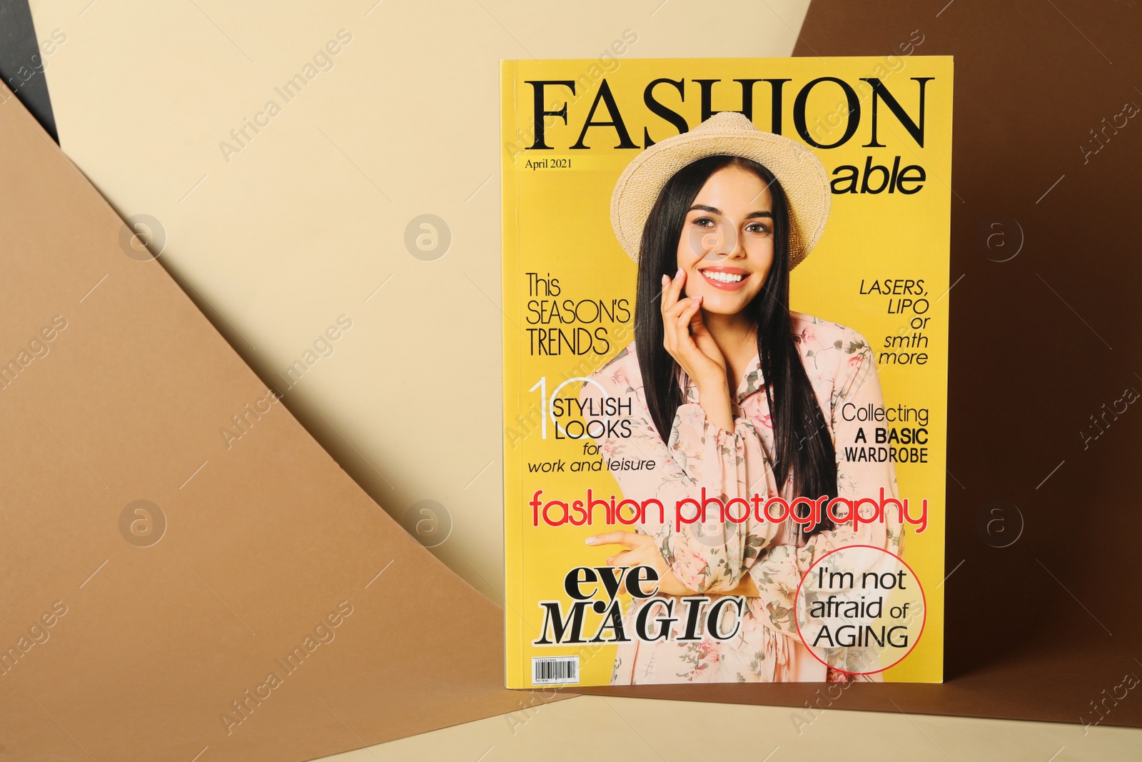 Photo of Modern printed fashion magazine on color background, space for text