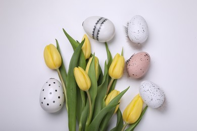 Beautiful tulips and eggs on white background, flat lay. Easter celebration