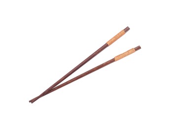 Pair of wooden chopsticks isolated on white, top view