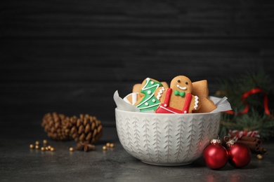 Photo of Tasty homemade Christmas cookies on grey table against dark background, space for text