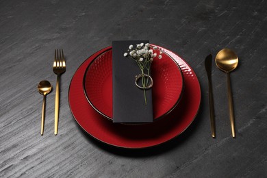 Photo of Elegant table setting. Plates, cutlery, napkin and floral decor