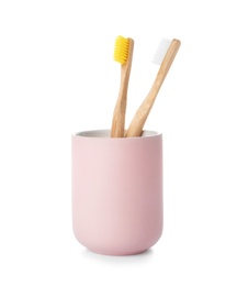 Photo of Bamboo toothbrushes in holder on white background. Dental care