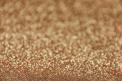 Photo of Gold glitter with bokeh effect as background, closeup