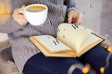 Woman with cup of coffee reading book with letters flying over it at home, closeup