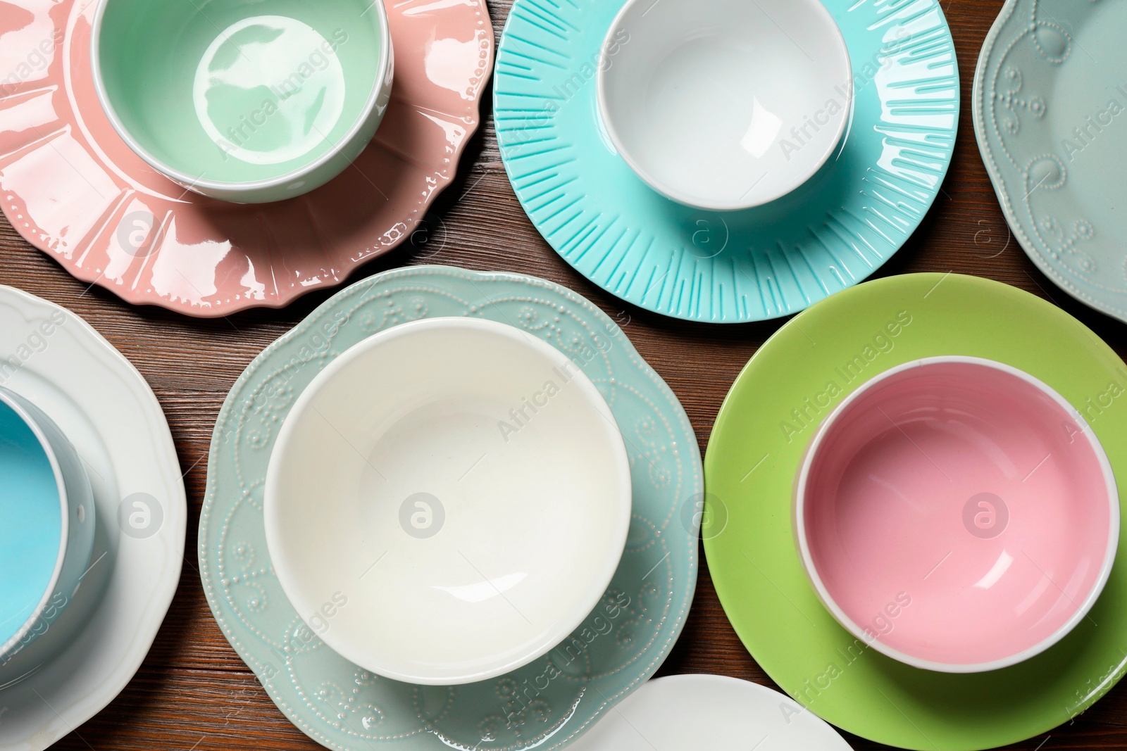 Photo of Beautiful ceramic dishware on wooden table, flat lay