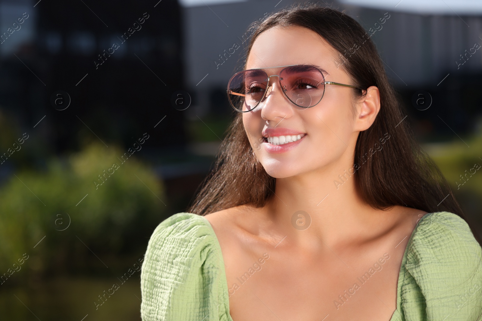 Photo of Beautiful smiling woman in sunglasses outdoors, space for text