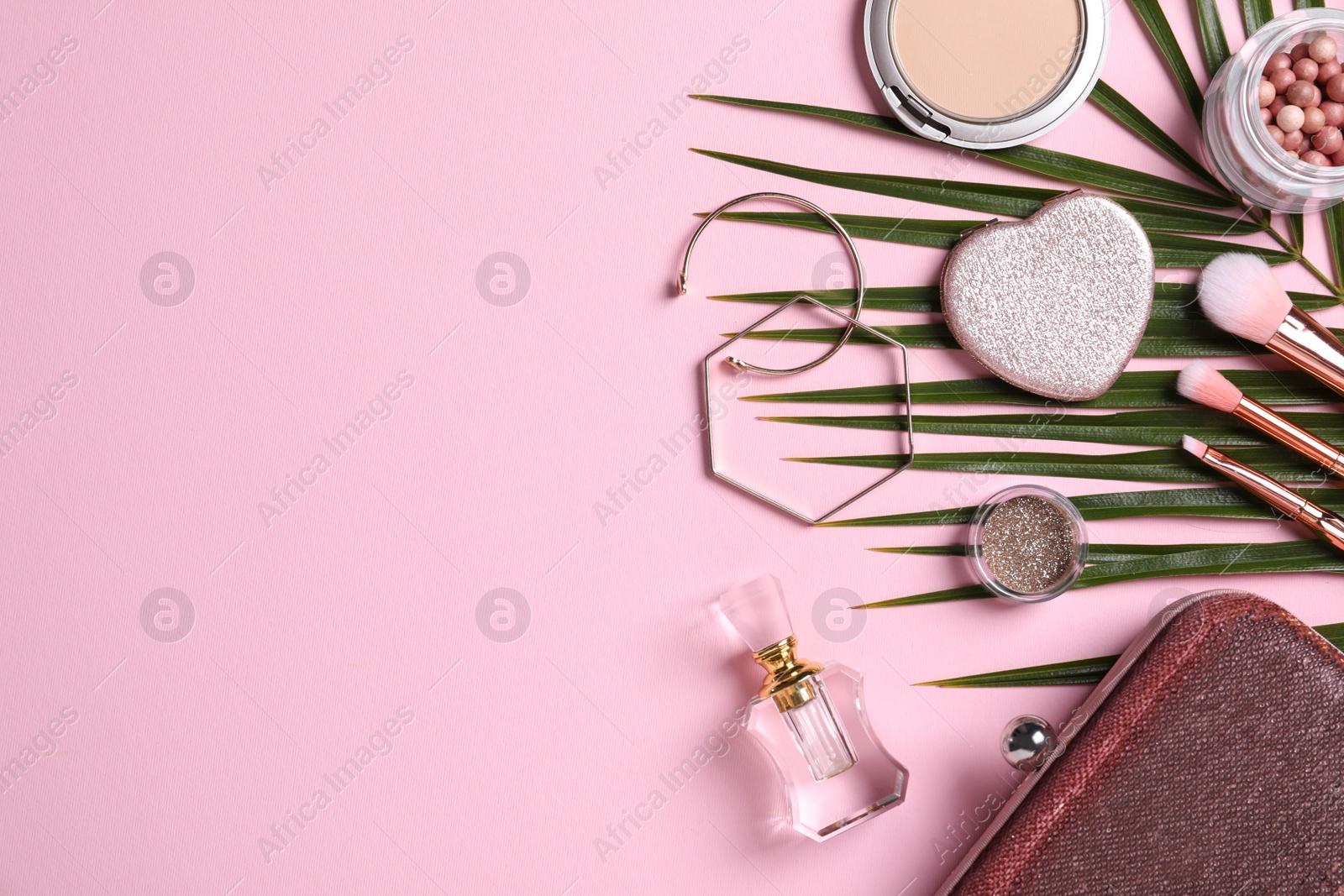 Photo of Flat lay composition with makeup products on pink background, space for text