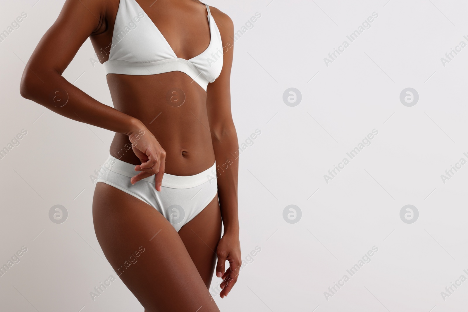 Photo of Woman in stylish bikini on white background, closeup. Space for text