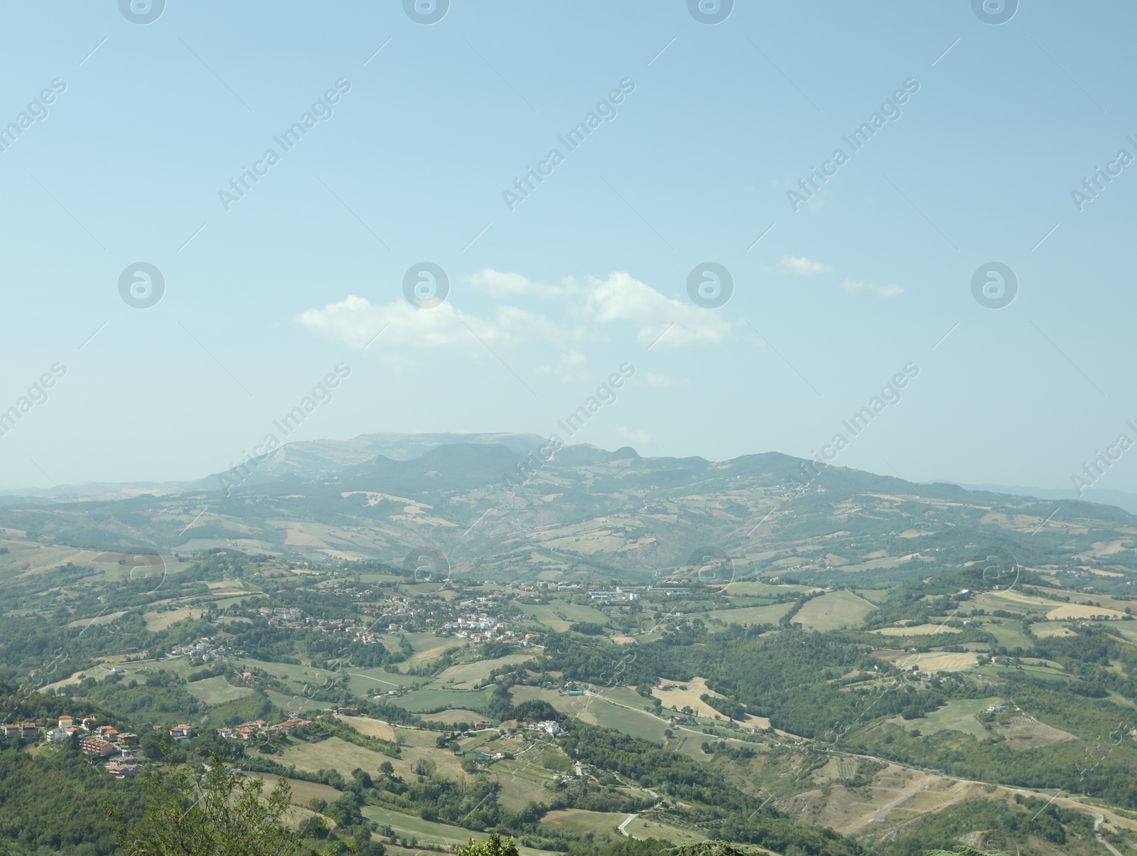 Photo of Aerial view of countryside and mountains on sunny day