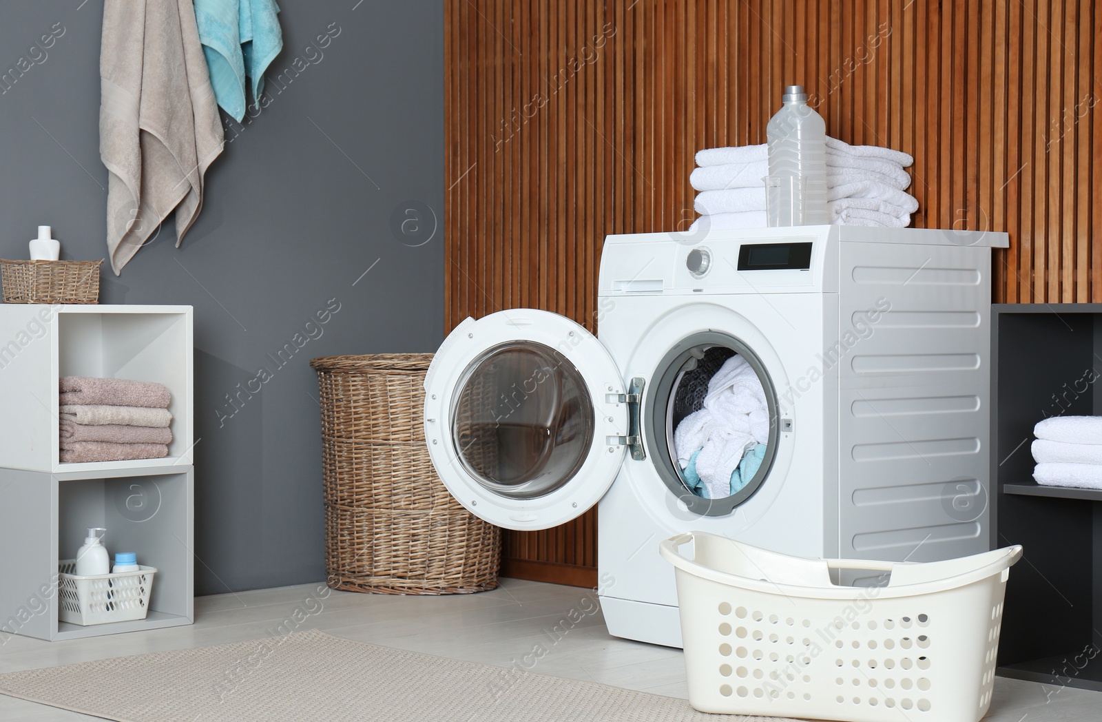 Photo of Crumpled towels in washing machine at home. Laundry room interior