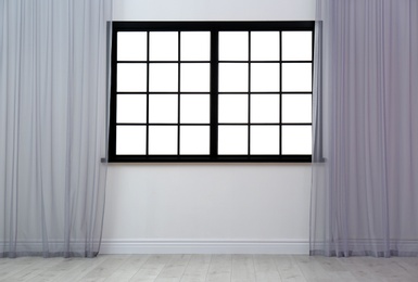 Photo of Empty room with window and open curtains. Home interior