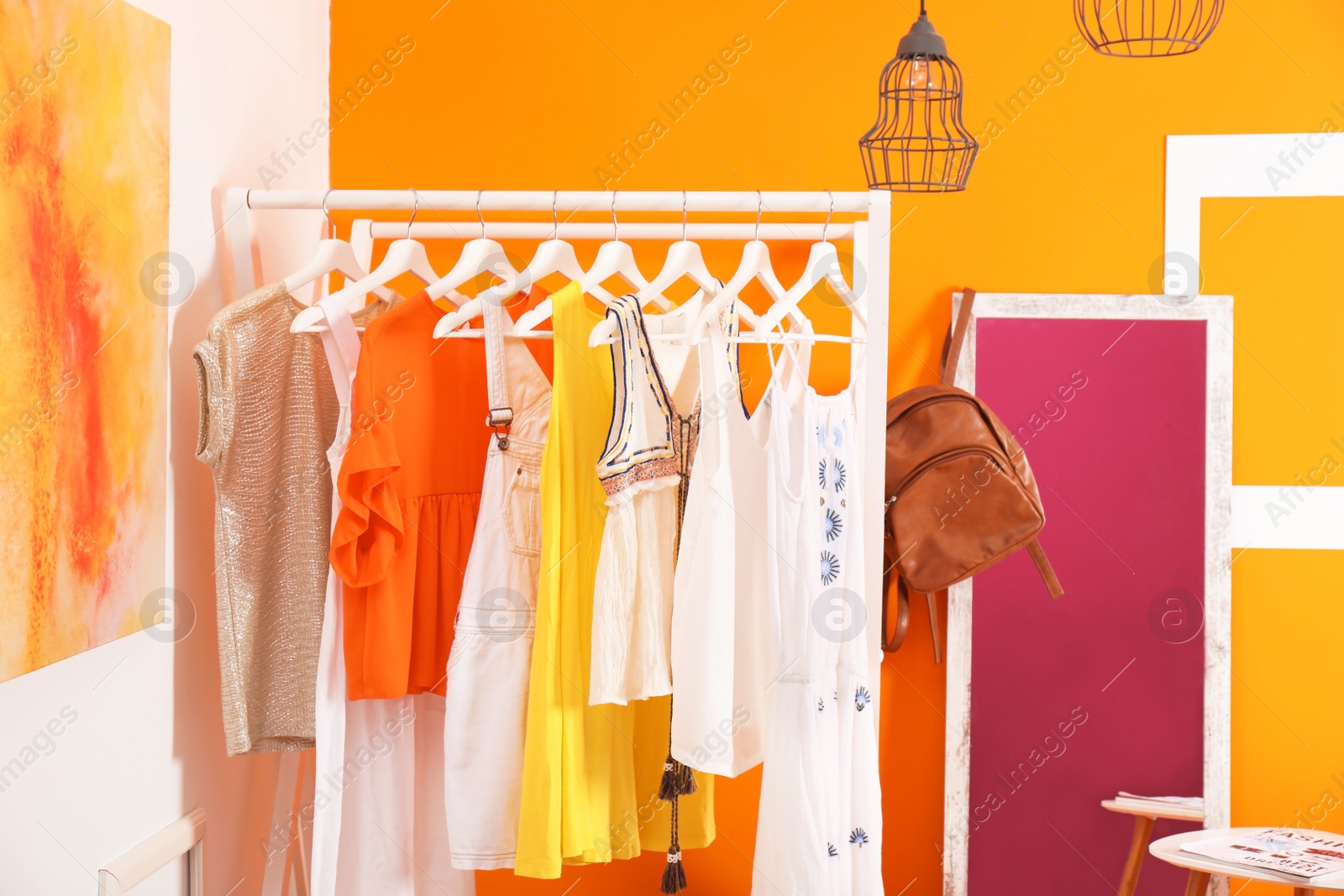 Photo of Stylish dressing room interior with clothes rack and mirror