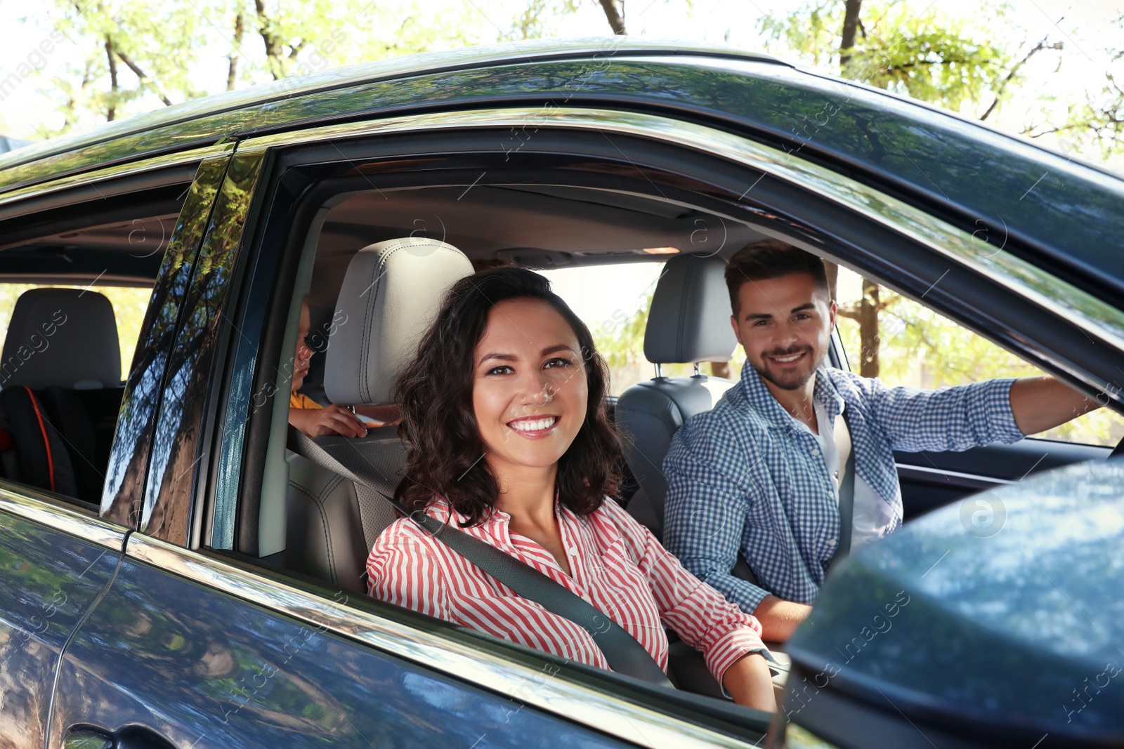 Photo of Happy family in car on road trip