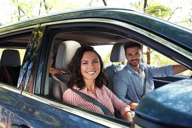 Photo of Happy family in car on road trip