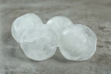 Photo of Frozen ice balls on grey table, closeup