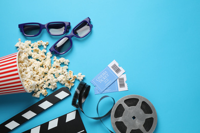 Photo of Flat lay composition with delicious popcorn on light blue background