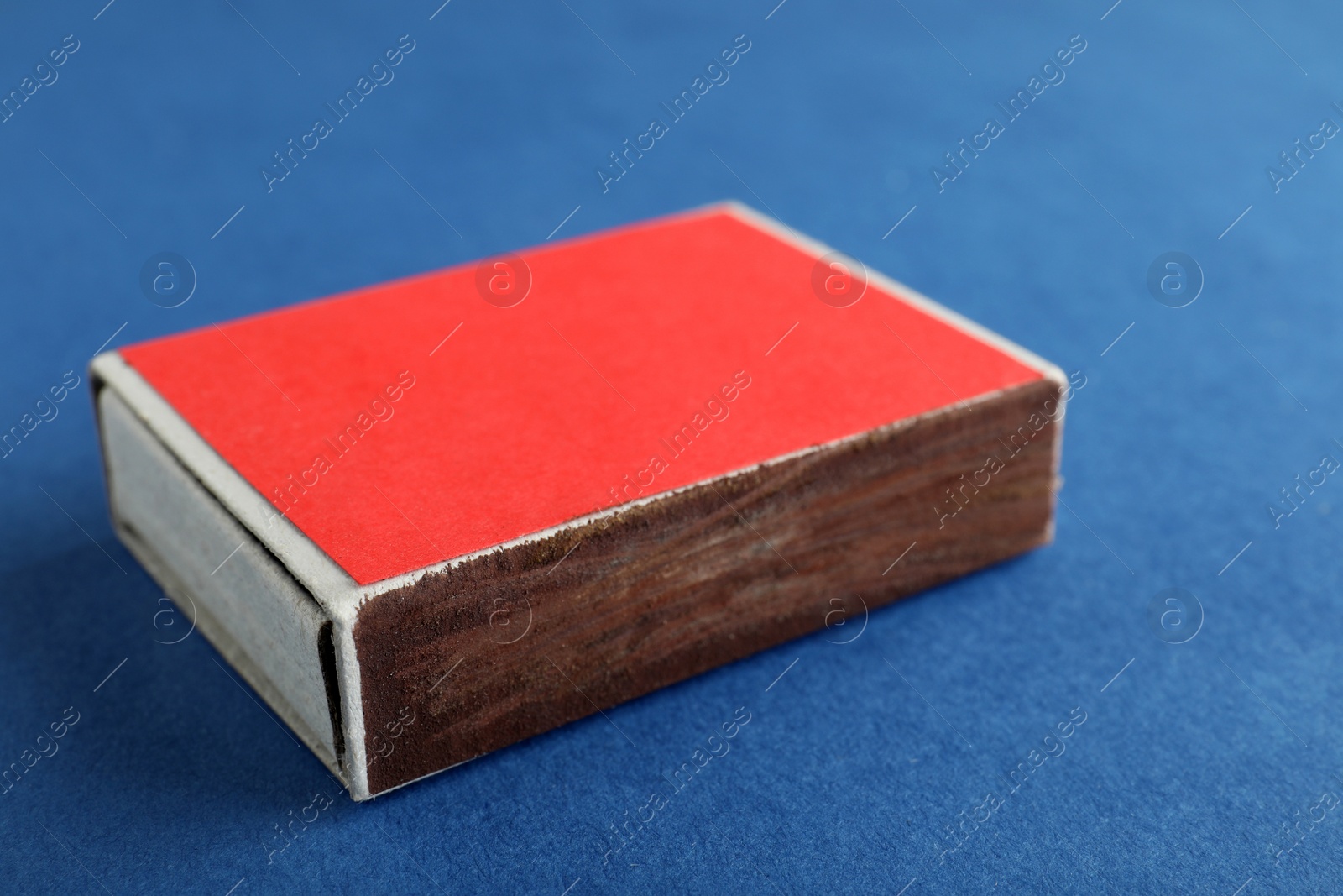 Photo of Red box of matches on color background, closeup